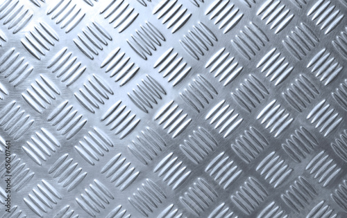 The old silver steel checkered plate background with scratches texture and light reflection on surface