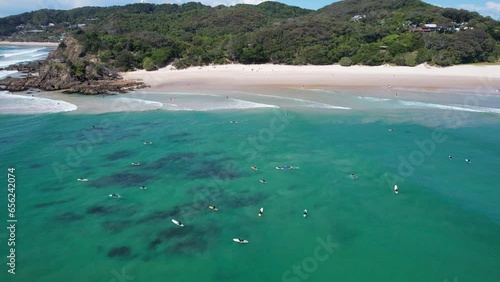 Surfers enjoying the sun and surf of Wategos Beach, Australia photo