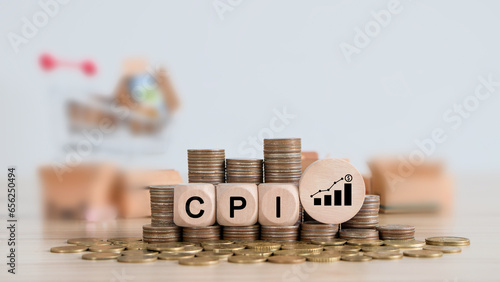 CPI, consumer price index concept. Wooden block with the words CPI on coins stack. Goods price inflation and inflation rising. Impact on economic growth with relate icon.