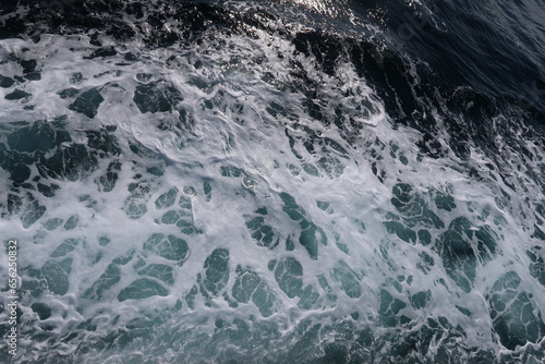 white sea foam on dark blue sea, splash 