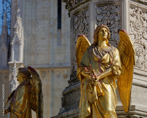 Selective focus photo of an Angel statue placed on a column in front of Zagreb Cathedral, Croatia