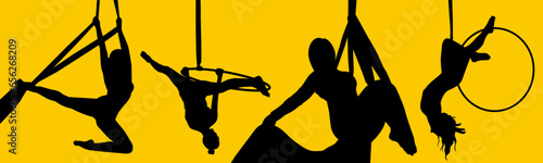 Pretty woman - aerialist doing acrobatic tricks on aerial silks