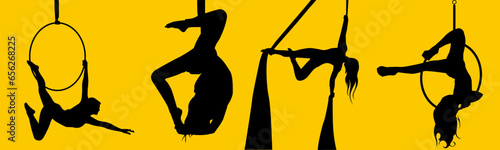 Pretty woman - aerialist doing acrobatic tricks on aerial silks