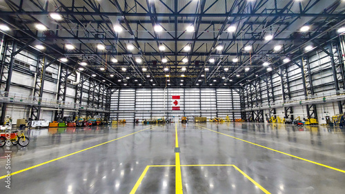 Photos An aircraft hangar sits empty with a well lit Canadian flag in the background tu