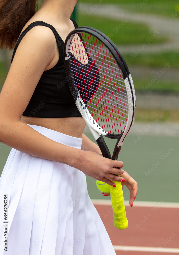 Girl with a racket on the tennis court
