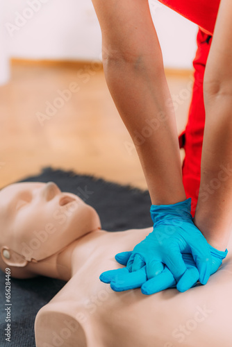 Obraz na płótnie Chest compression techniques in a CPR first aid training with a dummy.