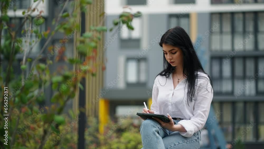 Female Freelancer Artist Drawing Digital Pictures On Graphics Tablet And Stylus In Park, Online Work Female Freelancer Artist Drawing Digital Pictures On Graphics Tablet And Stylus In Park, Online Work
