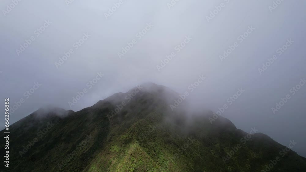 Nu‘uanu Pali - Clouds flowing over over ridges of cliff- stationary view Nu‘uanu Pali - Clouds flowing over over ridges of cliff- stationary view