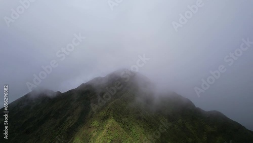 Nu‘uanu Pali - Clouds flowing over over ridges of cliff-  stationary view photo