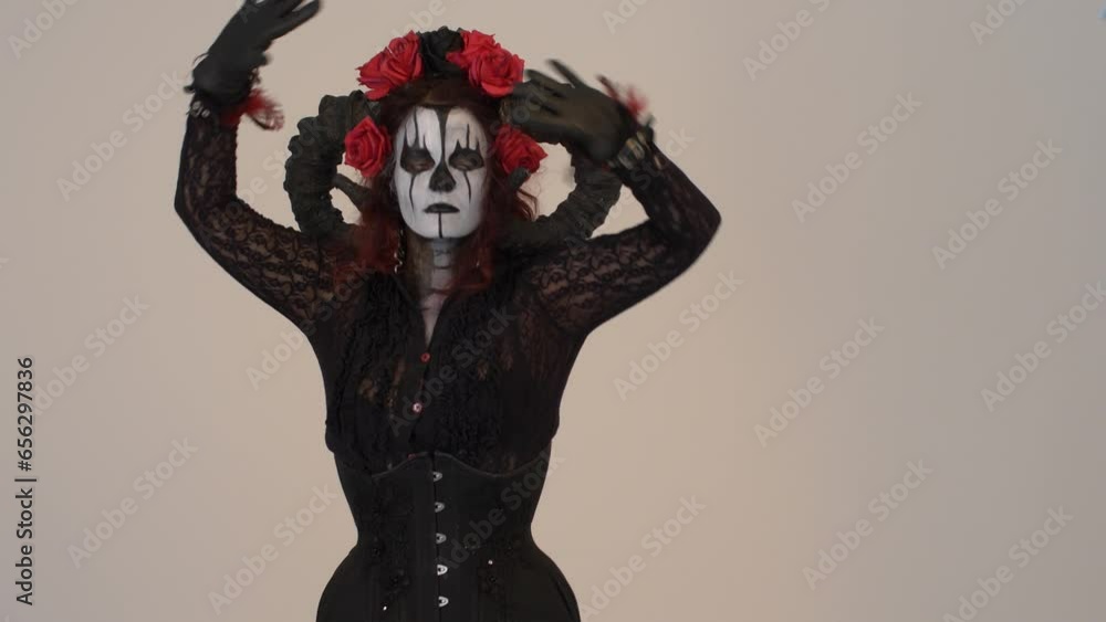 Catrina Cosplay girl slowly dancing with her hands sensually in a Light background, Medium shot Catrina Cosplay girl slowly dancing with her hands sensually in a Light background, Medium shot