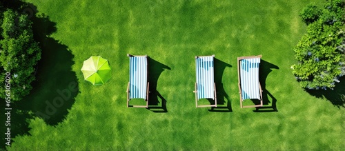 Top view of a green park with deckchairs and trees perfect for relaxation photo