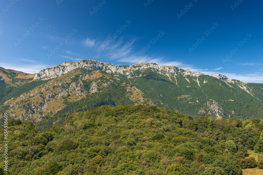 Baldo Mountain (Monte Baldo) in summer, east side, seen from the small village of Ferrara di Monte Baldo, Verona province. Mountain range between Lake Garda and Adige Valley, Italian Alps. Italy, Eu.