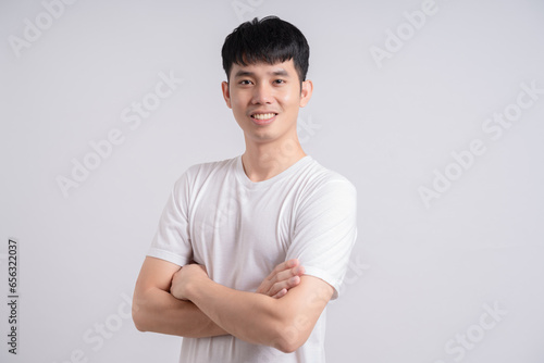 Man crossed arms close up of muscular man on white background.