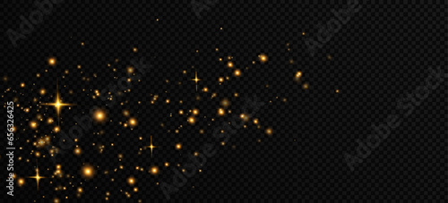 Golden sequins glow with many lights. Glittering dust. Luxurious background of golden particles.