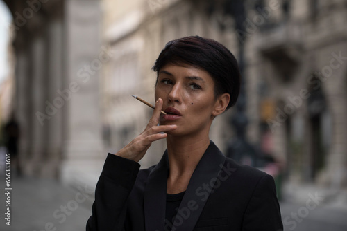 Cigarette in the hands of women. Smoke. 