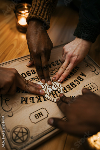 Multiracial friends using ouija board