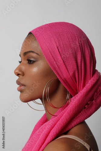 Vertical portrait of beautiful young woman with traditional turban posing indoor