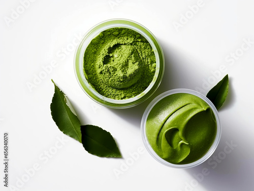 Superfood green powder in a small white bowl on white background. Matcha tea powder, spinach, chlorella, moringa, wheatgrass, or broccoli powder.