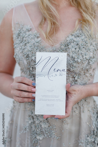 woman holding a wedding menu