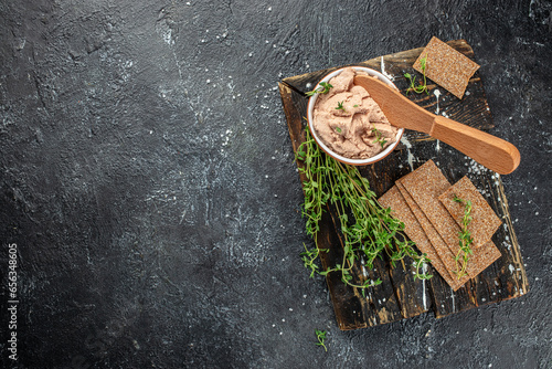 The bowl of pate on a dark background. Traditional French meat appetizer. banner, menu, recipe place for text, top view