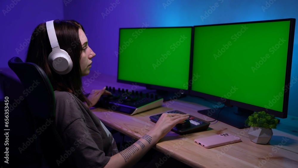 Portrait of female model in white headphones editing video on pc. Advertising area, workspace mockup. Portrait of female model in white headphones editing video on pc. Advertising area, workspace mockup.