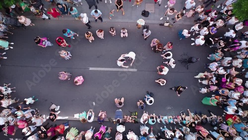 Top down aerial drone footage of people swing dancing in the streets. Noaptea Dansului - The night of the dances. Flash mob dancing swing dances.
