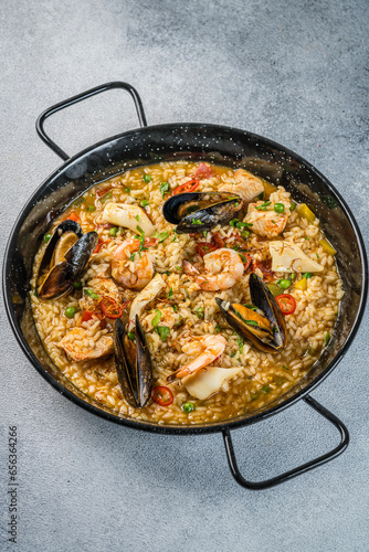 Italian Cuisine. Greek seafood and rice paella with shrimp, mussels and squid. on a light background. View from above