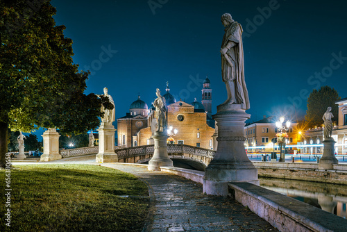 Padua, Italy - October 1, 2023: The Prato della Valle in the evening, is the largest square in the city of Padua. In the background the Church of Santa Giustina.