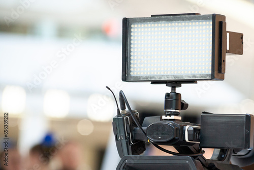 Wallpaper Mural Led lights panel on the camcorder. Professional video camera set. Front view of camcorder lens close up. Torontodigital.ca