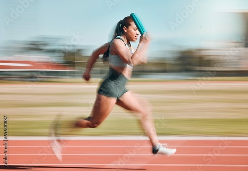 Action, speed and woman athlete running relay sprint in competition for fitness game and training for energy wellness on a track. Sports, stadium and athletic person or runner exercise and workout