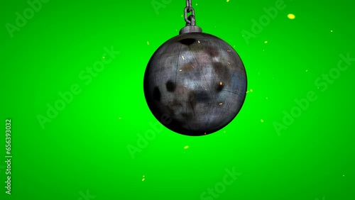 Metallic wrecking ball. Wrecking ball swinging in the foreground Chroma key. On green screen