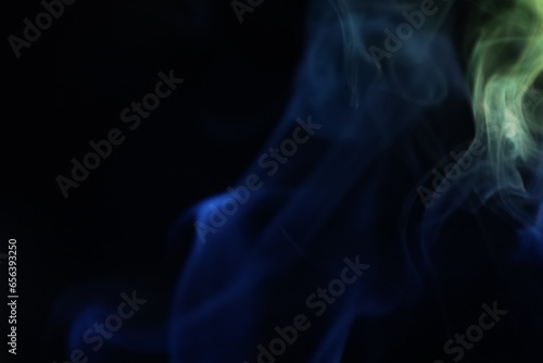 Yellow and blue smoke on a dark background, colourful abstract, one line, minimalistic art