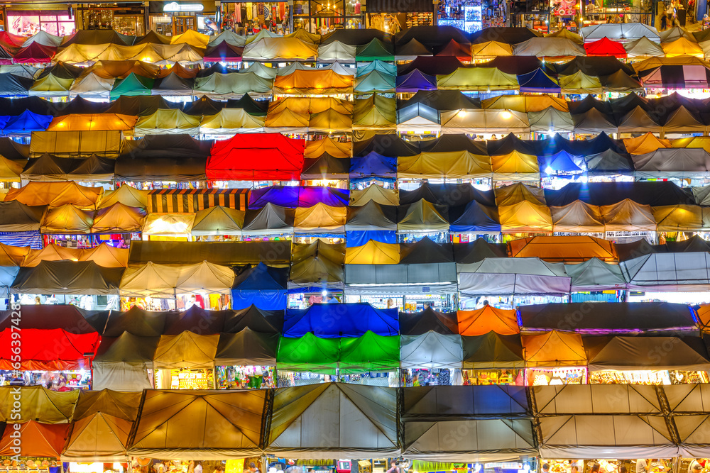 Close shot of colorful outdoor Asian night market tents and food
