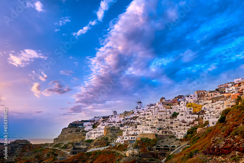 Oia village, windmills, Santorini island, Greece at colorful sunset