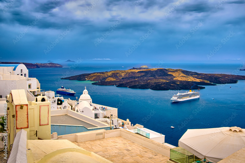 Aerial of Santorini island and towns and cruise ships in bay, Greece
