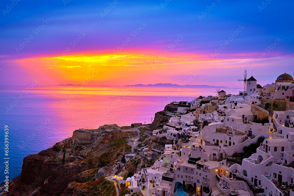 Oia village, windmills, Santorini island, Greece at colorful sunset