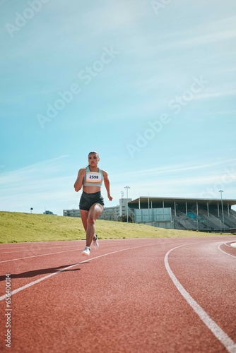 Fototapeta Naklejka Na Ścianę i Meble -  Woman, athlete and running on stadium track in fitness, workout or cardio exercise for practice or training. Female person or runner in sports competition, performance or outdoor motivation on mockup