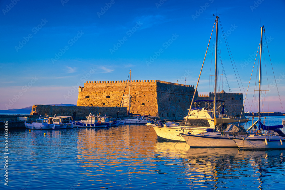 Venetian castle and fishing boats in bay of Heraklion, Crete, Greece