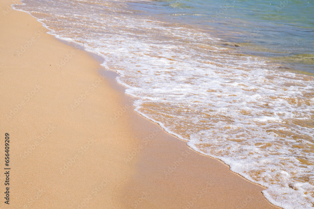 View at seashore with sea foam and sand View at seashore with sea foam and sand