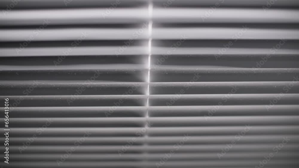 rays of light through blinds and illuminate a dark room, close-up rays of light through blinds and illuminate a dark room, close-up