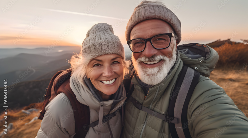 Old hiking couple with grey hear enjoy the beautiful sunset in the mountain during a hiking tour and making a happy smiling self portrait selfie, generative ai Old hiking couple with grey hear enjoy the beautiful sunset in the mountain during a hiking tour and making a happy smiling self portrait selfie, generative ai