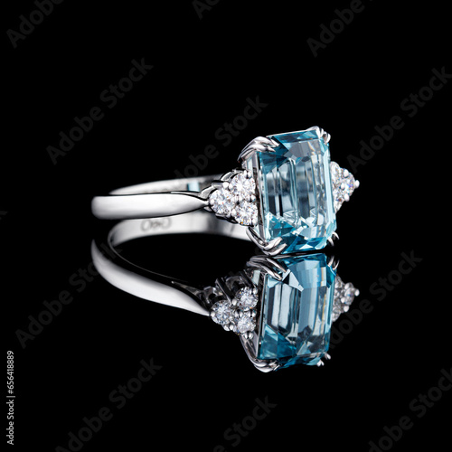 beautiful white gold ring with diamonds and aquamarine on a black background