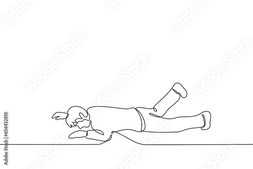 man fell to the ground or floor with his stomach down - one line art vector. concept of losing your balance, tripping and falling or lying on the floor and having a tantrum