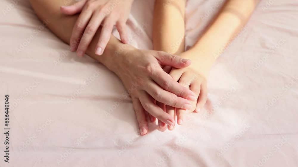 Top view of the hands of the mother and child touching each other. Close-up. The concept of love and trust in the family. Top view of the hands of the mother and child touching each other. Close-up. The concept of love and trust in the family.