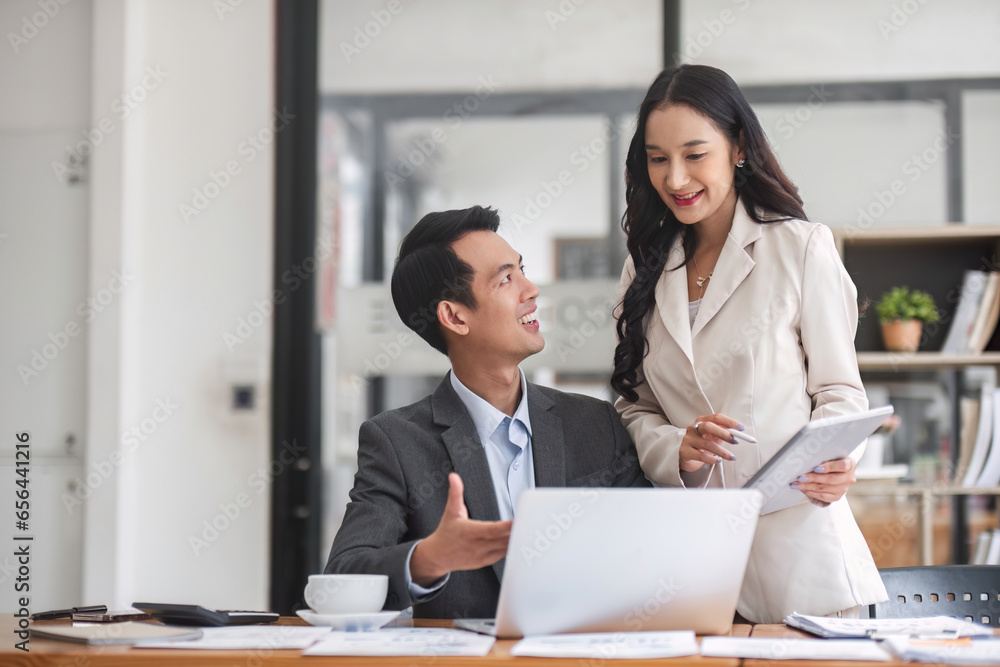 Asian business adviser meeting to analyze and discuss the situation on the financial report in the meeting room Investment Consultant. Asian business adviser meeting to analyze and discuss the situation on the financial report in the meeting room Investment Consultant.