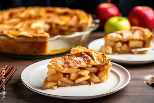apple pie with a single slice separated on the same dish photo