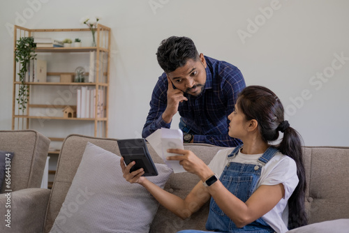 indian couple preparing bills to pay, husband and wife calculate the bills to pay, couple having financial problem