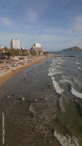 Top view of the beach in the morning Mazatlan vertical video waves in the summer in Mexico