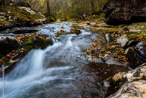 Waterfall. Tourism and travel in autumn. Holidays in the mountains.