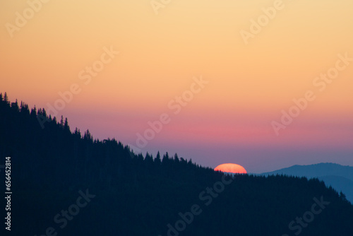 Sunrise sky over the Dragobrat in Carpathian mountains, Ukraine photo